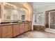 Elegant bathroom featuring double sinks, a soaking tub, and a separate shower with beautiful tile work at 1562 Suncrest Rd, Castle Rock, CO 80104
