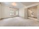 Inviting bedroom filled with natural light, featuring carpeted floors and an open doorway at 1562 Suncrest Rd, Castle Rock, CO 80104