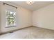Bright bedroom with a large window offering scenic views and plush carpeting at 1562 Suncrest Rd, Castle Rock, CO 80104