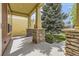 Covered porch with decorative stone supports adding character and curb appeal to the home at 1562 Suncrest Rd, Castle Rock, CO 80104