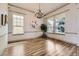 Elegant dining room featuring a chandelier, large windows, and beautiful hardwood floors at 1562 Suncrest Rd, Castle Rock, CO 80104