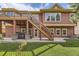 Exterior of a two-story home with a deck, stairs to the backyard, and a hot tub area at 1562 Suncrest Rd, Castle Rock, CO 80104