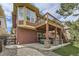 Exterior view of a home featuring a deck, backyard stairs, and a hot tub area at 1562 Suncrest Rd, Castle Rock, CO 80104