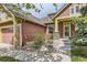 Charming home featuring an inviting front porch and stone accents around the entryway at 1562 Suncrest Rd, Castle Rock, CO 80104