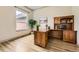 Well-lit home office with hardwood floors, built in shelving, and a large window at 1562 Suncrest Rd, Castle Rock, CO 80104