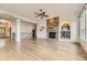 Open-concept living room with a stone fireplace and a staircase leading to the upper level at 1562 Suncrest Rd, Castle Rock, CO 80104