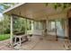 Covered patio with a concrete floor and simple metal furniture overlooking the green backyard at 6371 Brooks Dr, Arvada, CO 80004