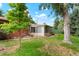 The backyard has lush landscaping and a sunroom, providing a relaxing outdoor living space at 6371 Brooks Dr, Arvada, CO 80004