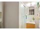 Cozy bathroom featuring a stand-up shower with glass doors, vanity and decorative mirror at 6371 Brooks Dr, Arvada, CO 80004