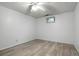 Bedroom with neutral vinyl flooring, white walls, a ceiling fan, and a small window at 6371 Brooks Dr, Arvada, CO 80004