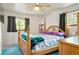 Bedroom featuring a traditional poster bed, ceiling fan and views of the exterior at 6371 Brooks Dr, Arvada, CO 80004