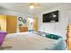 Bedroom featuring a large bed, ceiling fan and mounted television at 6371 Brooks Dr, Arvada, CO 80004