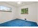 Light and airy bedroom featuring large windows, ample natural light, and blue carpet at 6371 Brooks Dr, Arvada, CO 80004