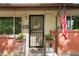 Charming porch featuring a decorative wreath, potted plants, and an American flag creating a warm, welcoming entrance at 6371 Brooks Dr, Arvada, CO 80004