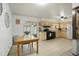 Well-lit kitchen features a breakfast area, ample cabinet space, and a smooth transition to an outdoor patio, perfect for dining at 6371 Brooks Dr, Arvada, CO 80004