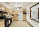 Functional kitchen with essential appliances, ample cabinet space, and neutral tiling, providing a practical cooking area at 6371 Brooks Dr, Arvada, CO 80004