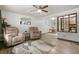 Bright living room featuring hardwood floors, ceiling fan, and comfortable seating, creating an inviting and airy space at 6371 Brooks Dr, Arvada, CO 80004