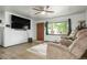 Bright and airy living room featuring hardwood floors, ample natural light, and a cozy seating arrangement for relaxation at 6371 Brooks Dr, Arvada, CO 80004