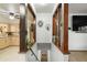 Open stairwell featuring decorative shelving that connects the kitchen to the home's upper level at 6371 Brooks Dr, Arvada, CO 80004