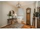 Foyer with a grandfather clock, wooden table, rug, and a decorative mirror at 10431 Marigold Ct, Highlands Ranch, CO 80126