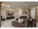 Relaxing space with a brown sectional sofa, a large screen TV, and a bar seating area at 10431 Marigold Ct, Highlands Ranch, CO 80126