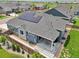 Aerial view of home featuring solar panels, covered patio, and a well-maintained landscaped backyard at 15987 E 115Th Pl, Commerce City, CO 80022