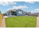 View of the home's expansive backyard featuring a lush green lawn and well-maintained landscaping at 15987 E 115Th Pl, Commerce City, CO 80022