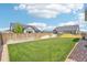 Fenced backyard featuring an expansive green lawn, bordered by decorative gravel and landscaping at 15987 E 115Th Pl, Commerce City, CO 80022