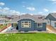 Aerial view of backyard with covered patio, lush lawn, and beautiful landscaping for outdoor enjoyment at 15987 E 115Th Pl, Commerce City, CO 80022