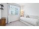 Bright bedroom with a daybed, large window with a view, and a whimsical decorative pillow at 15987 E 115Th Pl, Commerce City, CO 80022