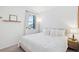 Bedroom with a bright window, minimalist decor, and a fluffy, cozy bed at 15987 E 115Th Pl, Commerce City, CO 80022