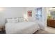 Bedroom with a plush, soft bed and adjoining bathroom with granite counter and wood cabinets at 15987 E 115Th Pl, Commerce City, CO 80022