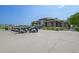 View of a clubhouse featuring a row of parked golf carts, providing convenience for golfers at 15987 E 115Th Pl, Commerce City, CO 80022