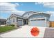 Beautiful single-Gathering home featuring a three-car garage, stone accents, and well-maintained landscaping at 15987 E 115Th Pl, Commerce City, CO 80022