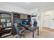 Spacious home office featuring custom built-ins, a large desk, and comfortable seating at 15987 E 115Th Pl, Commerce City, CO 80022