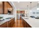Modern kitchen with stainless steel appliances, a spacious island, and ample cabinet space at 15987 E 115Th Pl, Commerce City, CO 80022