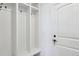 Mudroom featuring a built-in storage system, white wainscoting, and a convenient coat rack at 15987 E 115Th Pl, Commerce City, CO 80022