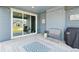 Covered patio with sliding glass doors and decorative rug offers outdoor seating and relaxing space at 15987 E 115Th Pl, Commerce City, CO 80022