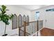 Stairway featuring a wood railing with decorative metal, decorative wall panels and hardwood flooring at 15987 E 115Th Pl, Commerce City, CO 80022