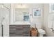Modern bathroom featuring a gray vanity, glass shower, and stylish decor at 3550 W 63Rd Ave, Denver, CO 80221