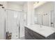 Modern bathroom featuring a glass-enclosed shower, sleek vanity, and contemporary finishes at 3550 W 63Rd Ave, Denver, CO 80221