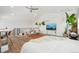 Bright loft bedroom with a cozy seating area, entertainment center, and natural light at 3550 W 63Rd Ave, Denver, CO 80221