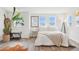 Well-lit bedroom featuring a cozy bed, stylish decor, and ample natural light from multiple windows at 3550 W 63Rd Ave, Denver, CO 80221