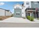 Well-maintained home with a spacious driveway and manicured lawn, showcasing its curb appeal and inviting atmosphere at 3550 W 63Rd Ave, Denver, CO 80221
