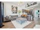 Stylish living room featuring a modern sofa, ottoman, and a striking art piece at 3550 W 63Rd Ave, Denver, CO 80221