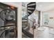 Modern home design featuring a distinctive spiral staircase and laundry appliances at 3550 W 63Rd Ave, Denver, CO 80221