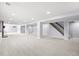Spacious basement area with neutral carpet, support beams, and stairs leading to the upper level at 2484 E 101St Ct, Thornton, CO 80229
