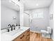 Well-lit bathroom with modern fixtures, hardwood flooring, and a clean, minimalist design at 2484 E 101St Ct, Thornton, CO 80229