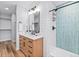 Stylish bathroom with a modern vanity, shiplap walls, and a tiled shower area at 2484 E 101St Ct, Thornton, CO 80229