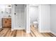 Contemporary bathroom showcasing wood-look floors, modern vanity, walk-in shower, and separate toilet at 2484 E 101St Ct, Thornton, CO 80229